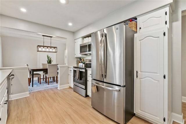 208 Chan Mowr Dr, Middlesex Twp, PA 16059 - kitchen with appliances with stainless steel finishes, light wood-style floors, white cabinetry, recessed lighting, and light countertops