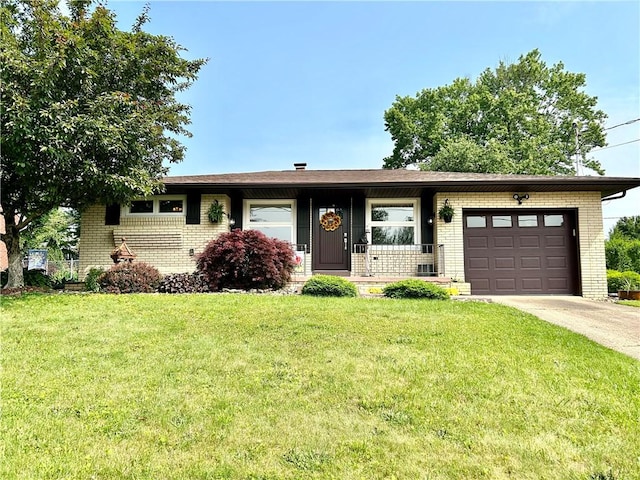 206 Richards Dr, Derry Twp, PA 15650 - ranch-style house with brick siding, an attached garage, concrete driveway, and a front lawn