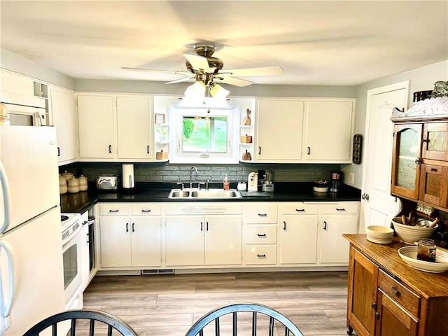 206 Richards Dr, Derry Twp, PA 15650 - kitchen with a sink, white appliances, dark countertops, and backsplash