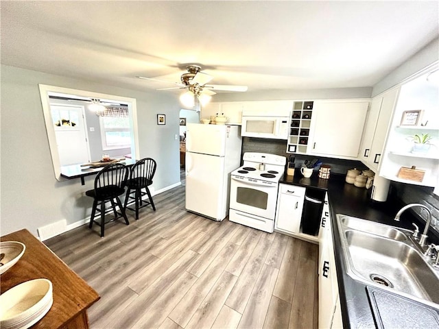 206 Richards Dr, Derry Twp, PA 15650 - kitchen featuring white appliances, a sink, dark countertops, ceiling fan, and white cabinets