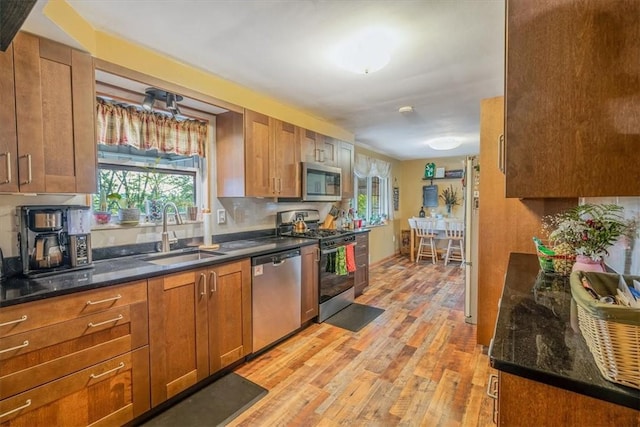 3804 Cynthia Dr, Baldwin Boro, PA 15227 - kitchen featuring stainless steel appliances, a sink, light wood-type flooring, brown cabinets, and plenty of natural light