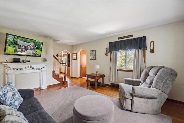 801 4th St N, Versailles, PA 15137 - living area featuring arched walkways, stairway, wood finished floors, and baseboards