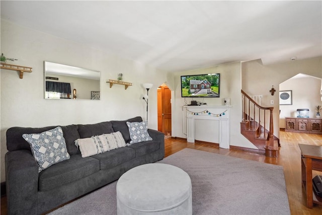 801 4th St N, Versailles, PA 15137 - living room featuring arched walkways, wood finished floors, and stairway