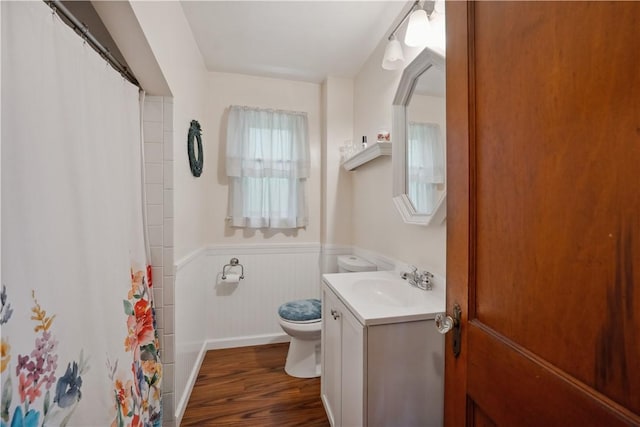 801 4th St N, Versailles, PA 15137 - full bathroom with toilet, vanity, wood finished floors, wainscoting, and curtained shower