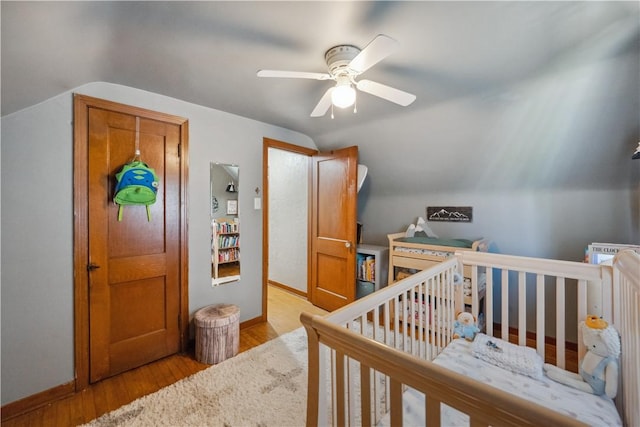801 4th St N, Versailles, PA 15137 - bedroom featuring vaulted ceiling, wood finished floors, baseboards, ceiling fan, and a nursery area