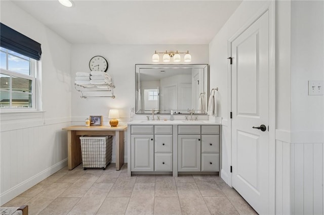 108 Berkshire Ct, Ohio Twp, PA 15237 - full bathroom featuring double vanity, a wainscoted wall, tile patterned floors, and baseboards