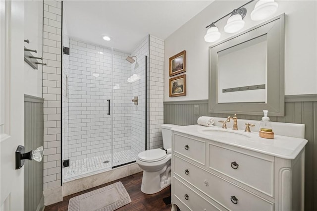 108 Berkshire Ct, Ohio Twp, PA 15237 - bathroom featuring vanity, toilet, wood finished floors, a shower stall, and a wainscoted wall