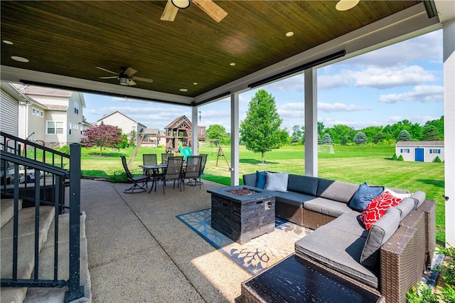 565 Tara Ct, Saxonburg Boro, PA 16056 - view of patio / terrace with a ceiling fan, an outdoor living space with a fire pit, outdoor dining area, and a playground