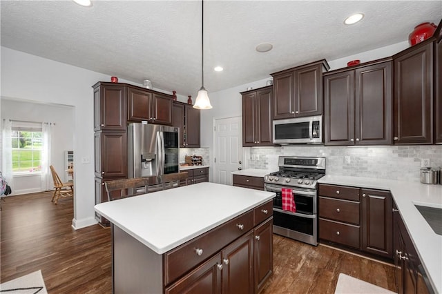 565 Tara Ct, Saxonburg Boro, PA 16056 - kitchen featuring stainless steel appliances, dark wood finished floors, dark brown cabinets, light countertops, and a center island