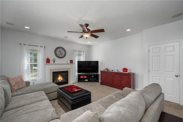 565 Tara Ct, Saxonburg Boro, PA 16056 - living room featuring light carpet, a glass covered fireplace, a ceiling fan, and recessed lighting