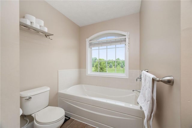 565 Tara Ct, Saxonburg Boro, PA 16056 - bathroom with toilet, a garden tub, a textured ceiling, and tile patterned flooring