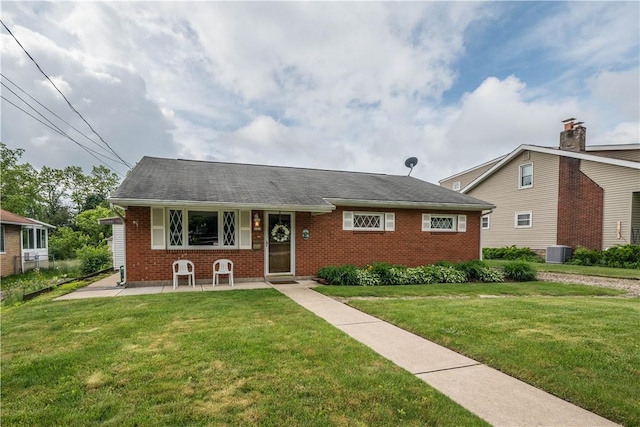 102 Jordan St, Bethel Park, PA 15102 - view of front of property featuring brick siding, a front lawn, and central AC