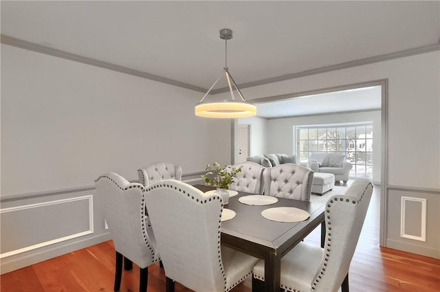 9 Victoria Dr, Neshannock Twp, PA 16105 - dining space with crown molding, light wood-style flooring, and a wainscoted wall