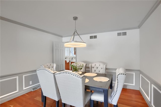 9 Victoria Dr, Neshannock Twp, PA 16105 - dining area with a wainscoted wall, a decorative wall, and wood finished floors