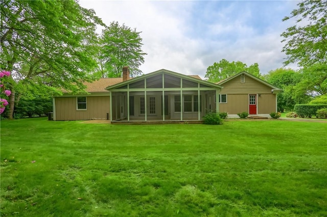 9 Victoria Dr, Neshannock Twp, PA 16105 - rear view of house with a chimney, a sunroom, and a lawn