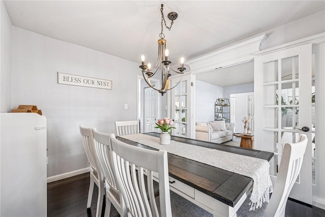 536 Cherryhill Dr, Cecil, PA 15017 - dining area featuring a chandelier, dark wood-type flooring, and baseboards
