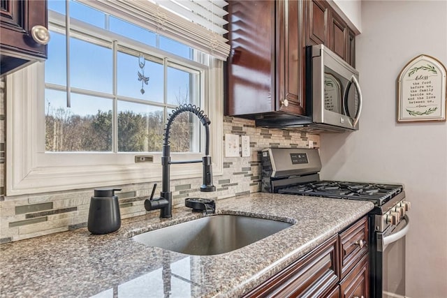 536 Cherryhill Dr, Cecil, PA 15017 - kitchen featuring stainless steel appliances, a sink, backsplash, and light stone counters