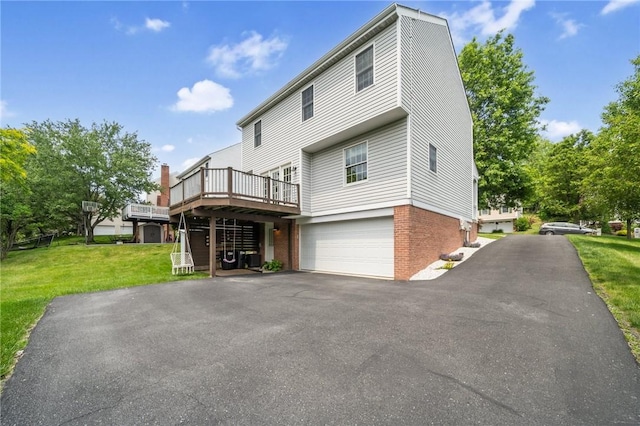 536 Cherryhill Dr, Cecil, PA 15017 - back of house with a wooden deck, a yard, brick siding, asphalt driveway, and a garage