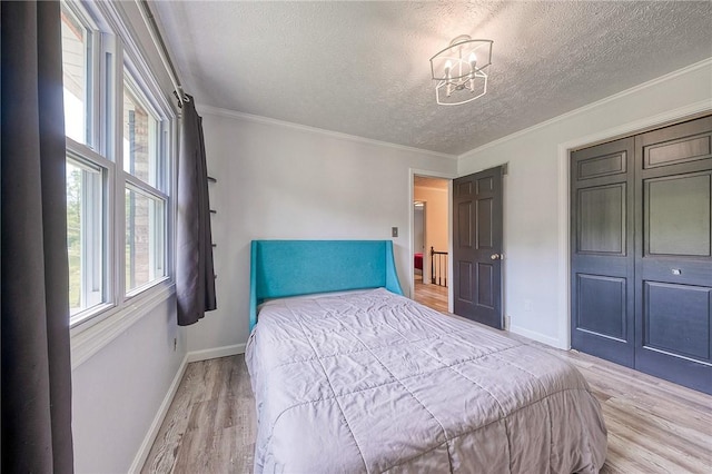 4822 W State St, Mahoning Twp Law, PA 16116 - bedroom with a textured ceiling, light wood-style flooring, baseboards, a chandelier, and crown molding