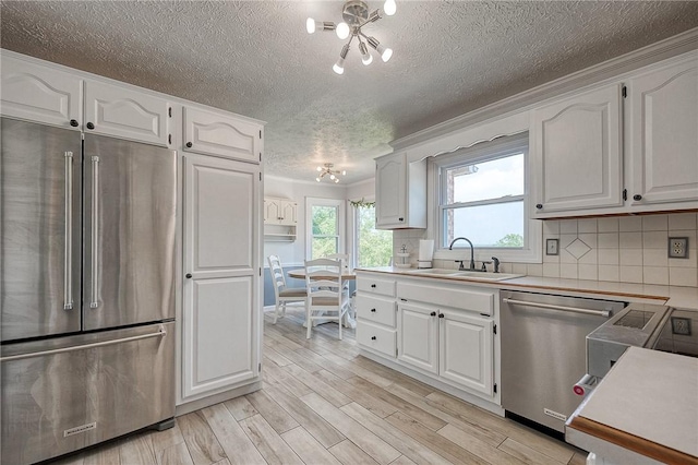 4822 W State St, Mahoning Twp Law, PA 16116 - kitchen with stainless steel appliances, a sink, a textured ceiling, light wood-style floors, and white cabinets