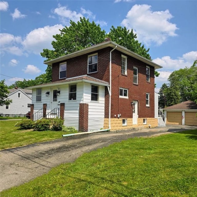 1911 Carolyn St, Farrell, PA 16121 - view of front of house featuring a front yard, brick siding, an outdoor structure, and a detached garage