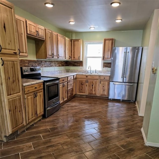 1911 Carolyn St, Farrell, PA 16121 - kitchen featuring stainless steel appliances, a sink, dark wood finished floors, light countertops, and tasteful backsplash