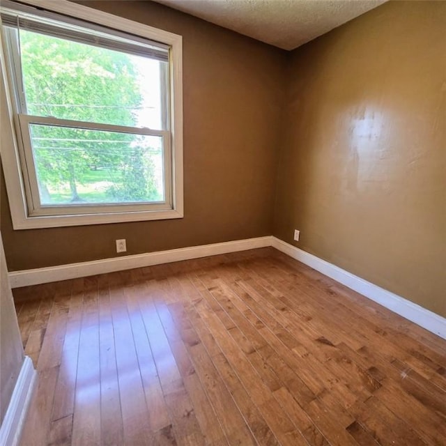 1911 Carolyn St, Farrell, PA 16121 - unfurnished room with hardwood / wood-style floors, baseboards, and a textured ceiling