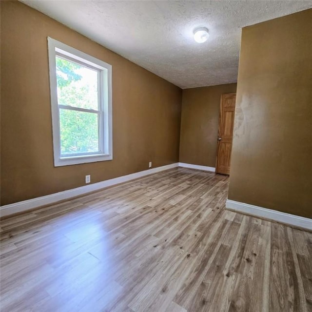 1911 Carolyn St, Farrell, PA 16121 - unfurnished room with wood finished floors, a textured ceiling, and baseboards
