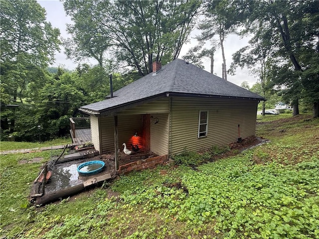 520 Palmer Rd, German Twp, PA 15410 - view of side of home featuring roof with shingles and a chimney