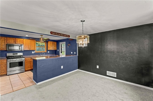 582 Brinwood Ave, Baldwin Boro, PA 15227 - kitchen featuring appliances with stainless steel finishes, a sink, light carpet, a chandelier, and brown cabinetry