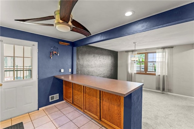 582 Brinwood Ave, Baldwin Boro, PA 15227 - kitchen with a ceiling fan, a peninsula, a chandelier, brown cabinetry, and hanging light fixtures