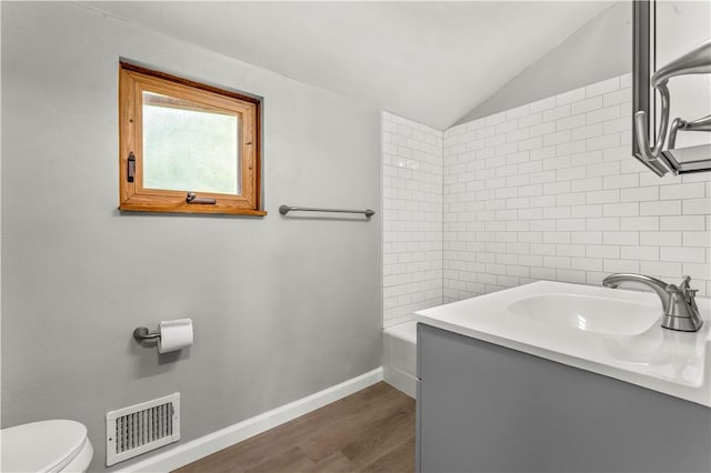 582 Brinwood Ave, Baldwin Boro, PA 15227 - full bath featuring toilet, vanity, wood finished floors, vaulted ceiling, and baseboards