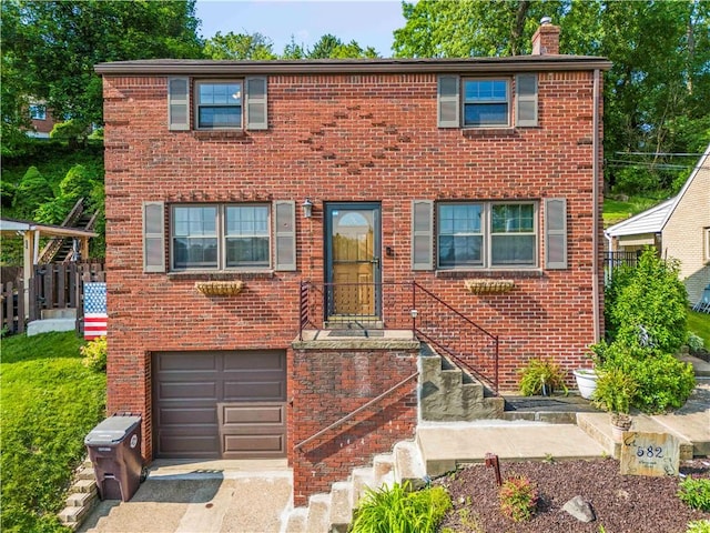 582 Brinwood Ave, Baldwin Boro, PA 15227 - view of front of home featuring an attached garage, brick siding, a chimney, and driveway