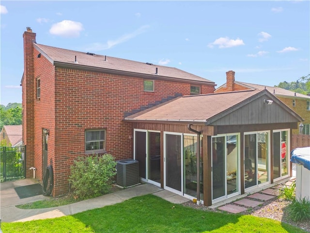 582 Brinwood Ave, Baldwin Boro, PA 15227 - rear view of property featuring cooling unit, brick siding, and a chimney