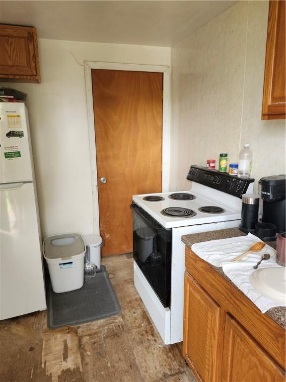 305 Charles Ter, Jeannette, PA 15644 - kitchen with white appliances, brown cabinets, and light countertops