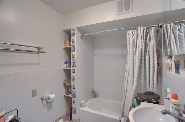 21 S Harrison Ave, Bellevue, PA 15202 - bathroom with tile walls, shower / bath combo with shower curtain, and a sink