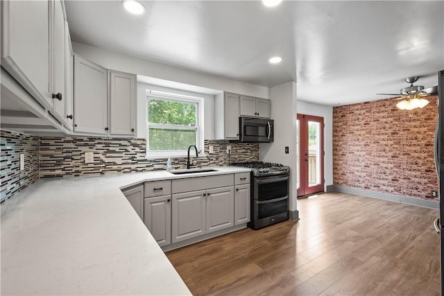 804 Division St, West Mifflin, PA 15122 - kitchen with range with two ovens, a sink, black microwave, plenty of natural light, and recessed lighting