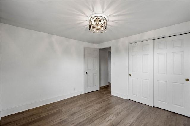 804 Division St, West Mifflin, PA 15122 - unfurnished bedroom featuring a chandelier, wood finished floors, baseboards, and a closet