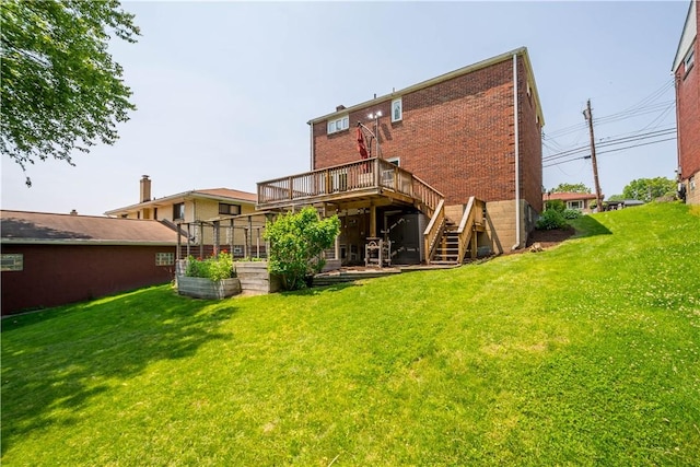 804 Division St, West Mifflin, PA 15122 - back of property featuring stairs, a wooden deck, brick siding, and a lawn