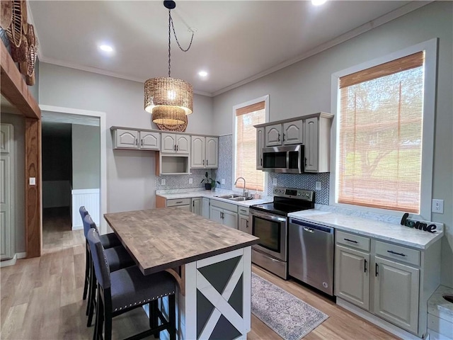 254 Bicker Rd, Winfield Twp, PA 16023 - kitchen with appliances with stainless steel finishes, gray cabinets, a sink, tasteful backsplash, and crown molding