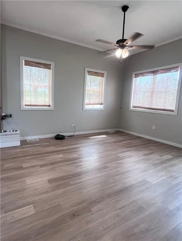 254 Bicker Rd, Winfield Twp, PA 16023 - empty room featuring plenty of natural light, ceiling fan, wood finished floors, baseboards, and ornamental molding