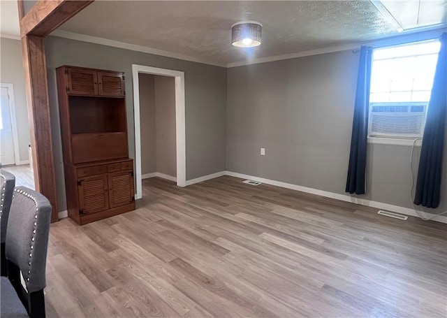 254 Bicker Rd, Winfield Twp, PA 16023 - unfurnished room with light wood-style floors, ornamental molding, baseboards, and attic access