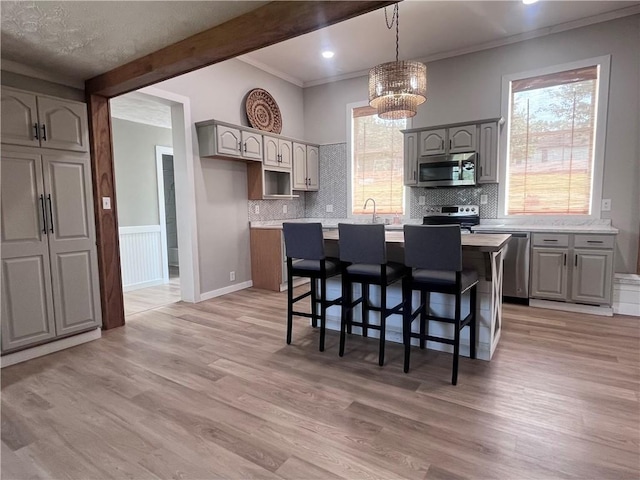 254 Bicker Rd, Winfield Twp, PA 16023 - kitchen featuring appliances with stainless steel finishes, a chandelier, crown molding, a kitchen island, and light countertops