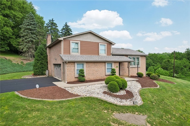 100 Welty Dr, Allegheny Twp Wml, PA 15068 - view of front of house with a garage, driveway, a front yard, and a chimney