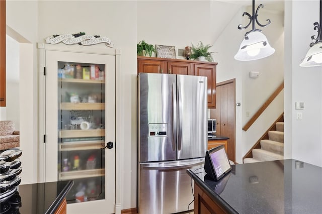 100 Welty Dr, Allegheny Twp Wml, PA 15068 - kitchen with stainless steel fridge with ice dispenser, dark countertops, brown cabinetry, and pendant lighting