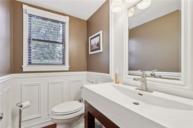 100 Welty Dr, Allegheny Twp Wml, PA 15068 - bathroom with wainscoting, vanity, toilet, and a decorative wall