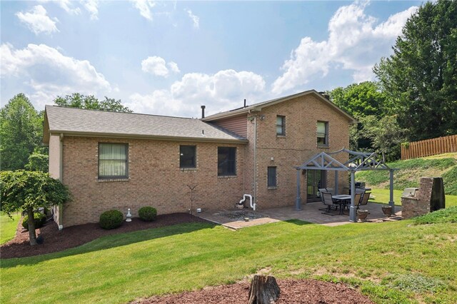 100 Welty Dr, Allegheny Twp Wml, PA 15068 - rear view of property featuring a patio area, brick siding, and a shingled roof