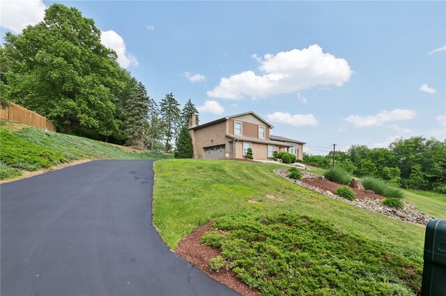 100 Welty Dr, Allegheny Twp Wml, PA 15068 - view of front of house featuring asphalt driveway, a chimney, and an attached garage