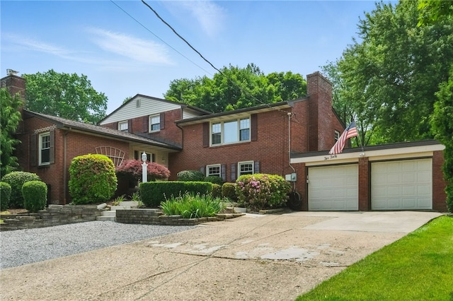 240 Patton Dr, Moon/Crescent Twp, PA 15108 - view of front facade with driveway, a chimney, an attached garage, and brick siding