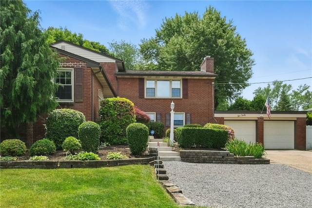 240 Patton Dr, Moon/Crescent Twp, PA 15108 - view of front of property with brick siding, a garage, concrete driveway, a chimney, and a front yard